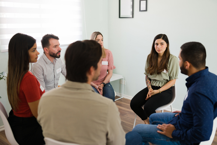 Young people offering advice to a latin man